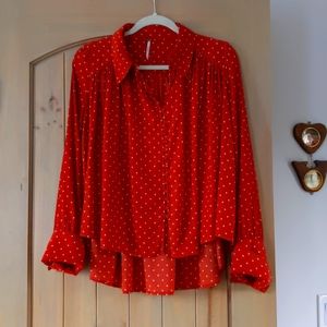 Free People women's long sleeved blouse with back tapering in rust color.